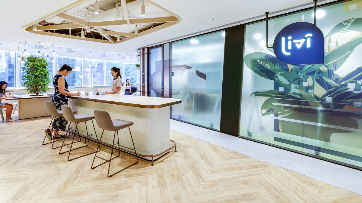high tables and people collaborating and seating in open office