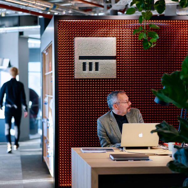 man sitting in front of pencil wall at london office