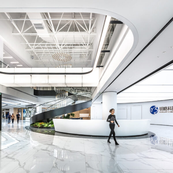 woman walking through white reception space