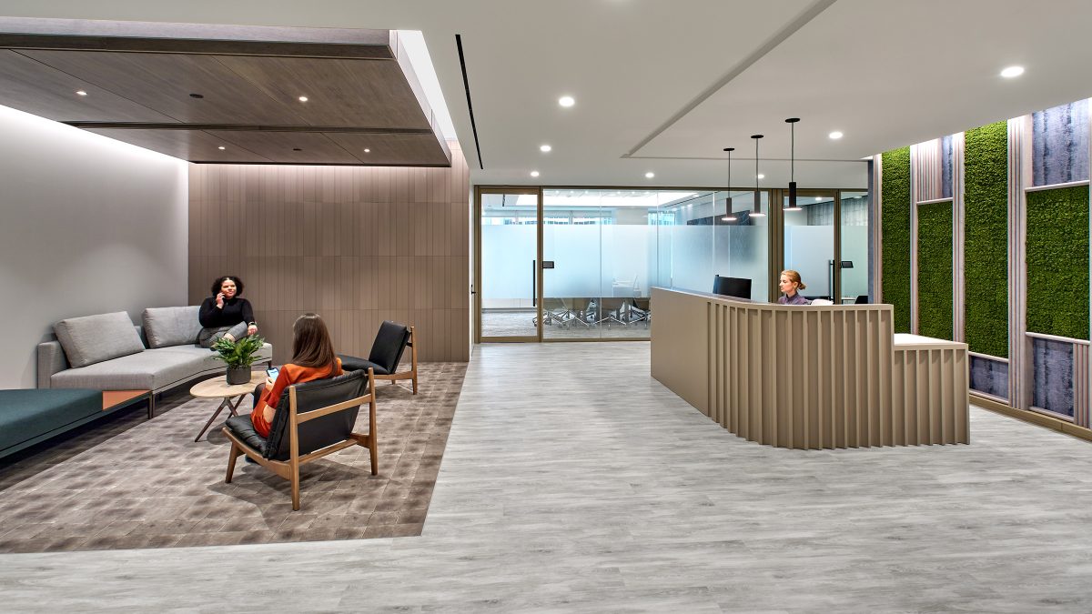 woman at reception and women in lounge area