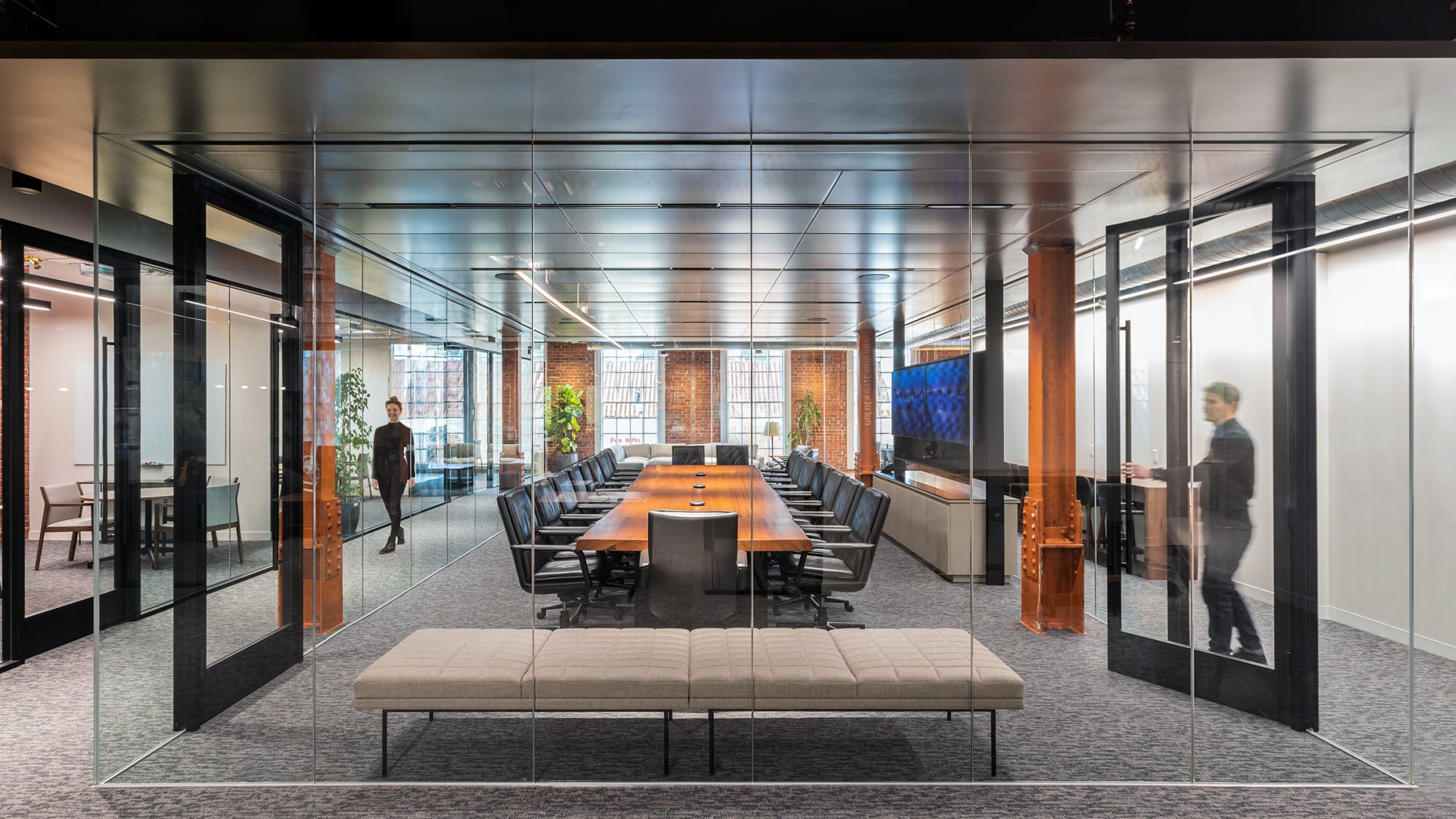 man opening boardroom door woman on other side