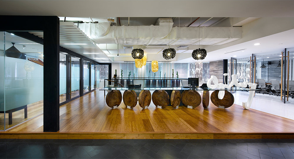 wood table, meeting room, view of logo and someone walking up staircase