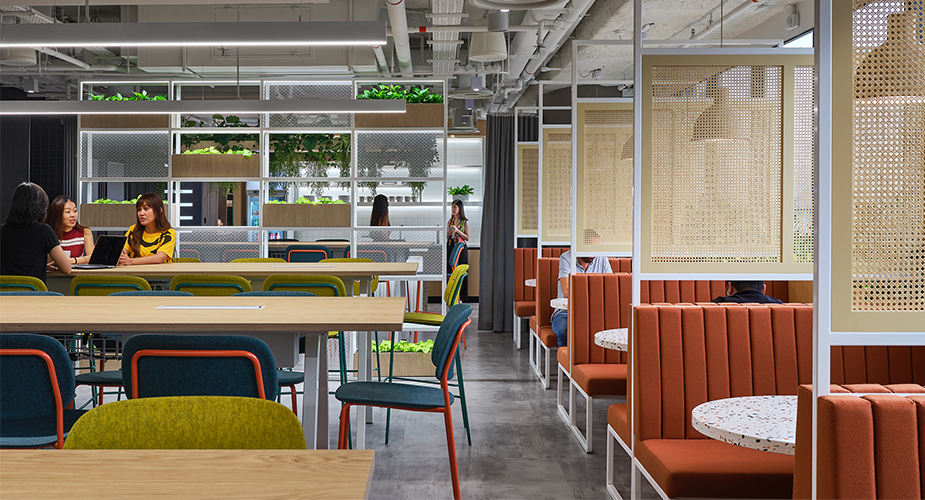 people collaborating at table and view of booths