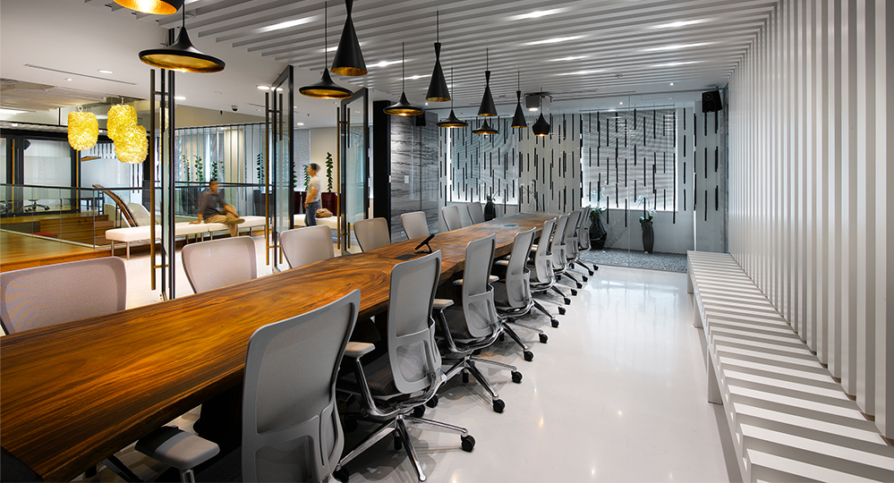 Conference room and men talking outside of room
