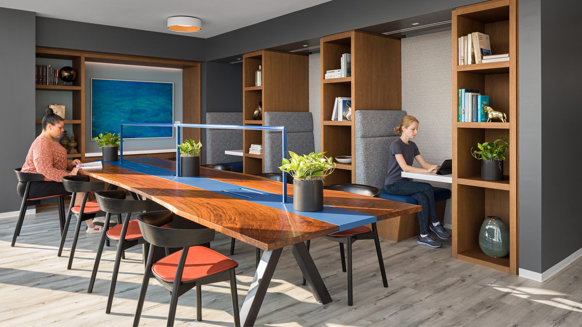 woman working in booth and woman working on table