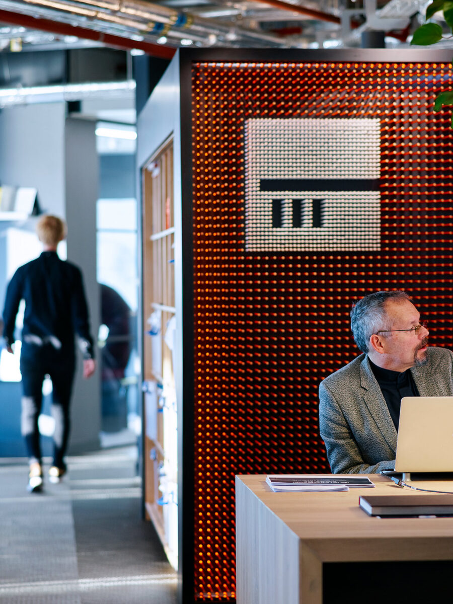 man working by branded wall
